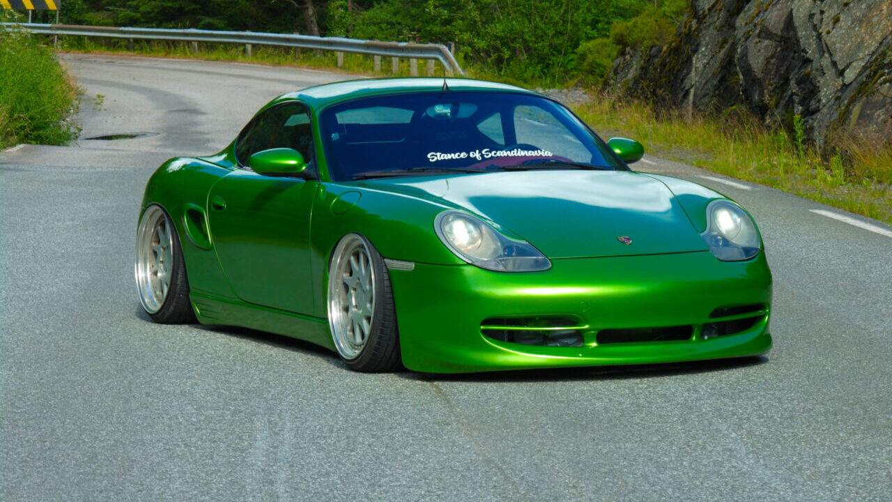 Stanced green Porsche Boxster 986 with airride and Rotiform wheels.