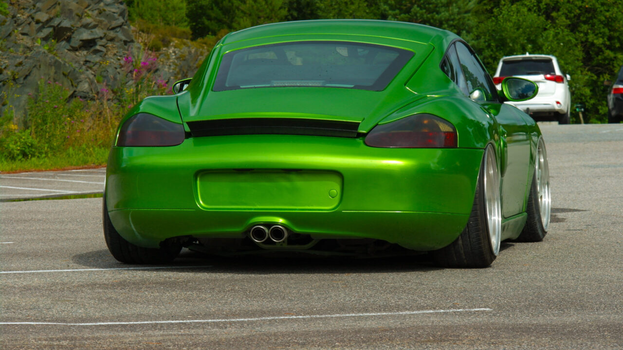 Stanced green Porsche Boxster 986 with airride and Rotiform wheels.