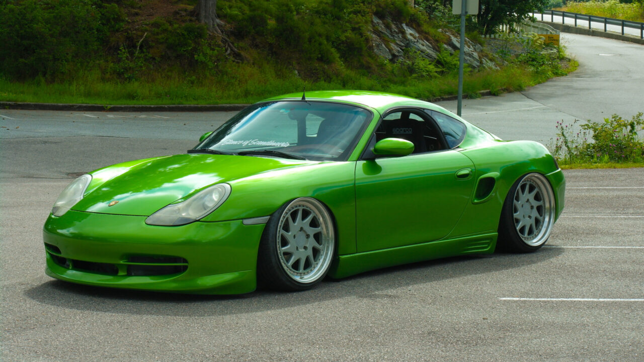 Stanced green Porsche Boxster 986 with airride and Rotiform wheels.