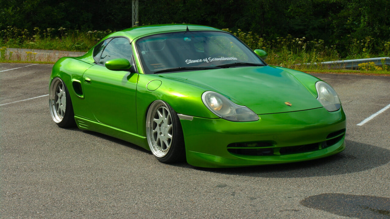 Stanced green Porsche Boxster 986 with airride and Rotiform wheels.