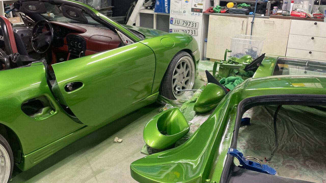 Stanced green Porsche Boxster 986 with airride and Rotiform wheels.